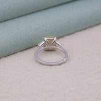 Silver ring with a yellow gemstone on a light gray surface, Yellow White CZ Ring