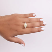 Hand wearing a diamond ring with a light-colored gemstone on a plain background, White Triangle Gemstone Ring