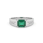 Silver ring with a green gemstone on a white background