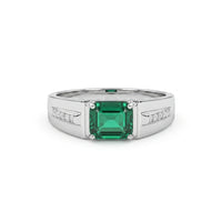 Silver ring with a green gemstone on a white background