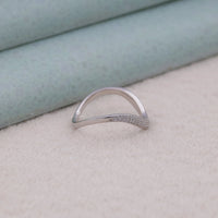 Silver ring with small stones on a light background, ring enhancer band, matching wedding band, women’s Moissanite ring, round Moissanite wedding band