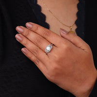 Hand wearing a diamond ring with a blurred background, Round Cut Solitaire Engagement Ring – Dragonfly Design White Gold Wedding Ring