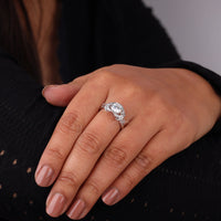 Close-up of a hand wearing a diamond ring with a blurred background, Dragonfly Design Round Cut Engagement Ring – White Gold Solitaire Wedding Ring