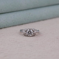 Silver ring with a diamond on a light gray surface, Vintage Round Solitaire Engagement Ring – Dragonfly Style White Gold Wedding Band