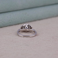 Silver ring with a diamond on a textured surface, Dragonfly Inspired Round Cut Solitaire Engagement Ring – Elegant White Gold Ring