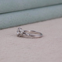 Silver ring with a diamond on a soft surface, Round Cut Solitaire Wedding Ring – Dragonfly Detail White Gold Engagement Jewelry