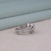 Silver ring with gemstone on a light background, Bridal Oval Moissanite Halo Ring with Split Shank & Matching Wedding Band