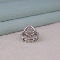 Silver ring with diamond accents on a light background, Oval Halo Moissanite Ring Set – Split Shank Engagement Ring with Enhancer Band