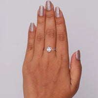 Hand wearing a diamond ring on a plain background, White Gold Pear Cut Moissanite Ring – Solitaire Engagement & Wedding Jewelry