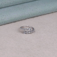 Silver ring with gemstones on a soft fabric background, graduated round stone ring, moissanite fashion accessory, bridal open ring, creative Moissanite setting