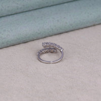 Silver ring with intricate design on a textured surface, Moissanite Statement Ring, Modern Twist Engagement Ring, Moissanite Finger Wrap Ring