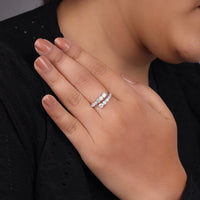 Hand wearing a diamond ring with a blurred background, unique bypass Moissanite ring, ring with open shank, modern jewelry design ring, Moissanite finger wrap ring, daily wear Moissanite ring