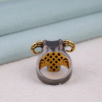 Metallic ring with intricate design on a light background, black round stone ring, animal skull ring, western skull ring, gold accent ring, vintage skull ring, unique skull ring, moody gemstone ring, dark aesthetic jewelry, men’s silver ring, statement silver ring,