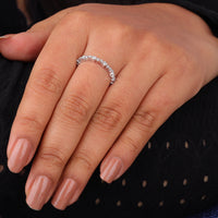 Close-up of a hand wearing a diamond ring on a dark background, Round Moissanite Minimalist Eternity Wedding Band For Women, Moissanite Eternity Band