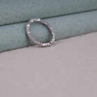 Silver ring with gemstones on a textured surface, Modern Minimalist Moissanite Ring, Sustainable Bridal Eternity Band, Sparkling Moissanite Stacking Band,