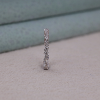 Silver ring with embedded stones on a textured surface, Minimalist Bridal Band, Eco Friendly Moissanite Wedding Ring, Classic Round Moissanite Eternity Band