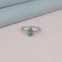 Silver ring with a blue gemstone on a light background, Eco Friendly Moissanite Anniversary Ring, Timeless Two Stone Moissanite Engagement Jewelry