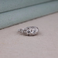 Silver ring with gemstones on a textured surface, Durable Vintage Engagement Ring, Moissanite Promise Ring With Milgrain Detailing, Bridal Jewelry With Three Moissanite Stones.