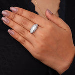 Hand wearing a diamond ring with a black background, Milgrain Art Deco Three Stone Ring With Round Moissanite, Art Deco Moissanite Engagement Ring