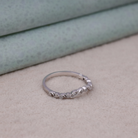 Silver ring with small diamonds on a beige surface, Vintage Inspired Art Deco Milgrain Leaf Wedding Band with Round Moissanite