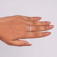 Hand wearing a diamond ring on a light gray background, Art Deco Leaf Wedding Band with Round Moissanite, Vintage Contour Ring