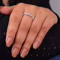 Close-up of a hand wearing a silver ring with a black background, Vintage Art Deco Milgrain Leaf Wedding Band, Contour Round Moissanite Ring