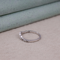 Silver ring with small diamonds on a textured surface, Vintage Inspired Art Deco Milgrain Leaf Wedding Band with Round Moissanite, Nature Inspired Leaf Moissanite Bridal Ring