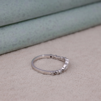 Silver ring with small diamonds on a beige surface, Round Moissanite Wedding Band, Sustainable Moissanite Nature Engagement Ring, Conflict Free Art Deco Moissanite Bridal Jewelry