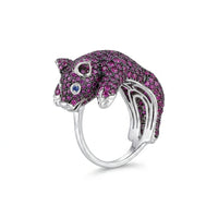 Cat-shaped ring with pink gemstones on a white background