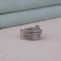 Silver ring with multiple rows of diamonds on a light gray surface, Elegant Criss Cross Moissanite Ring, Round Stone Multi Row Wedding Band