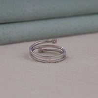 Silver ring on a textured surface with a blurred background
