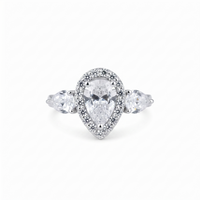Diamond ring with pear-shaped center stone and smaller stones on a white background