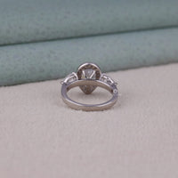 Silver ring with a diamond on a textured surface