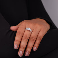 Hand wearing a diamond ring with a dark background, Leaf Inspired Moissanite Engagement Ring, Oval Marquise & Round Cut Moissanite Ring