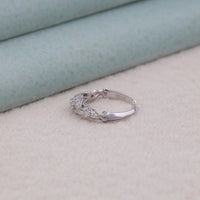 Silver ring with gemstones on a light background,unique Moissanite design, vintage bridal jewelry, minimalist wedding band, delicate Moissanite ring, handcrafted engagement ring, conflict-free Moissanite ring, halo-free engagement ring, fine Moissanite jewelry