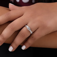 Close-up of a hand wearing a silver ring with intricate design on a dark , Moissanite Engagement Ring, background, Milgrain Art Deco Ring