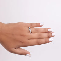 Hand wearing a diamond ring on a light gray background, Antique Style Moissanite Ring, Affordable Engagement Ring, Moissanite engagement ring, round cut Moissanite ring, minimalist Moissanite ring, milgrain Moissanite ring, Art Deco engagement ring, vintage inspired Moissanite ring, antique style engagement ring, round Moissanite solitaire