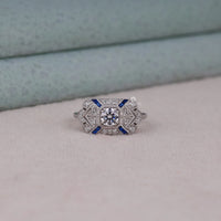 Diamond ring with blue accents on a light gray surface, Art Deco Inspired Blue Sapphire CZ Engagement Ring, Vintage Bridal Jewelry