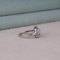 Silver ring with a diamond on a beige surface, Elegant Milgrain CZ Engagement Ring, Blue & White Sapphire Vintage Style Ring