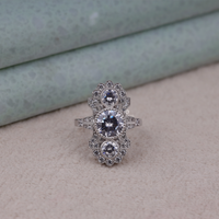 Silver ring with multiple gemstones on a soft surface, Elegant Art Deco Vintage Moissanite Ring, Three Stone Statement Engagement Jewelry