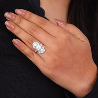 Close-up of a hand wearing a diamond ring on a dark background, Art Deco Moissanite Statement Ring, Vintage Three Stone Milgrain Engagement Jewelry