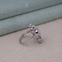 Silver ring with gemstones on a beige surface, Vintage Inspired Wedding Jewelry, Gorgeous Milgrain Moissanite Anniversary Ring, Elegant Three Stone Engagement Ring For Women