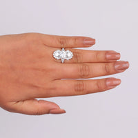 Hand wearing a diamond ring on a light gray background, Milgrain Art Deco Moissanite Ring, Vintage Style Three Stone Engagement Ring