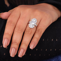 Close-up of a hand wearing a diamond ring on a dark background, Unique Art Deco Moissanite Engagement Ring, Vintage Three Stone Statement Jewelry
