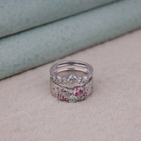 Two silver rings with gemstones on a neutral background, Blush Petal Pink With White Round CZ Stone Stackable Band Set, Pink and White CZ Wedding Band