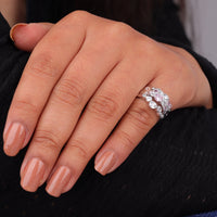 Close-up of a hand wearing a silver ring with gemstones on a dark background, Petal Pink and White Round CZ Stackable Ring Set, Minimalist Band Jewelry