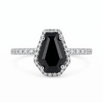 Ring with a black gemstone and diamond accents on a white background