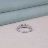 Silver ring with diamond on a light fabric background, Moissanite ring gift, wedding anniversary ring, classic round Moissanite ring, vintage inspired engagement band