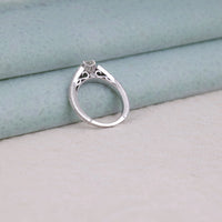 Silver ring with intricate design on a light blue fabric background,  conflict-free Moissanite ring, Moissanite ring for weddings, Art Deco style wedding band, Moissanite vintage style ring, classic bridal ring