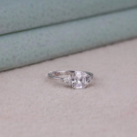 Silver ring with a large diamond on a light background, Modern Asscher & Triangle Moissanite Engagement Ring – Three Stone Bridal Ring